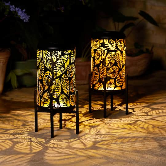 Glitzhome® 14.25" Black Metal Cutout Leaves Pattern Solar Powered LED Outdoor Lantern, 2ct.